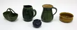 Luke Adams, Five assorted pieces, including two green glazed jugs, a basket, lidded sugar pot and a yellow glazed bowl