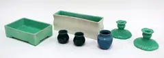 O.C Stephens, A pair of candlestick holders, together with two miniature vases, two trough vases and a small blue glazed vase