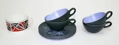 Dorothy Thorpe, Four ‘Pine’ pattern cups and saucers, together with a Royal Doulton ‘Maori Art’ tea cup