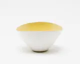 White tin glazed bowl by Dame Lucie Rie, with yellow glazed interior (hairline crack), sold Sep 2016