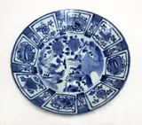 19th century by A large Japanese Arita blue and white dish, decorated in Kraak style with long tailed birds amongst peony, surrounded by panels with other flowers and auspicious sy, sold Sep 2016