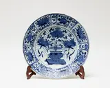 Edo period by A large Japanese Arita blue and white dish, decorated in Kraak style, the centre with pomegranate and peony sprays issuing from a vase, the rim with alternating pan, sold Sep 2016