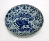 19th century by A large Japanese Arita blue and white dish, painted in Kraak style with a Shishi lion and cub to the centre, surrounded by panels of insects and flowers, sold Sep 2016