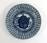 Meiji period by A Japanese Arita blue and white dish, painted and moulded with stylised lotus sides, the centre with auspicious symbols, sold Sep 2016