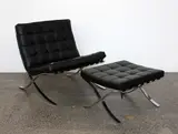 Barcelona chair and ottoman by Ludwig Mies van der Rohe, with chromium plated frame and black leather cushions, sold Mar 2015