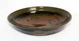 Stoneware bowl by Len Castle, tenmoku glaze with wax resist quince blossom decoration, sold Mar 2015