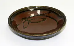 Stoneware bowl by Len Castle, with tenmoku glaze with quince blossom wax resist decoration, sold Mar 2015