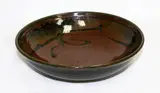 Stoneware bowl by Len Castle, tenmoku glaze with wax resist quince blossom decoration, sold Mar 2015