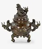 Meiji period (1868-1912) by Japanese bronze lidded koro [censer], with shishi lion handles and cover finial, sold Jul 2013