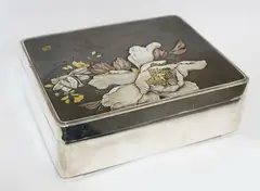 Meiji period (1868-1912) by Japanese silver box, with raised and inlaid in gold and copper decoration of peony and prunus branches, sold Jul 2013