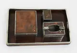 20th century by copper and wood smoking set Japanese four-piece silver, comprising lidded box, ashtray, match holder and tray, with silver and gold inlaid decoration, offered Jul 2013
