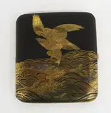 Fine Japanese iron cigarette case, early 20th century, inlaid in gold and silver with an eagle clutching a fish amongst waves