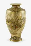 Large Japanese Satsuma vase, signed Kinkozan, Meiji period (1868-1912), decorated with figures at leisure in a garden, underneath wisteria branches