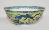 Guangxu iron-red six-character mark and of the period (1875-1908) by Chinese yellow ground famille rose bowl, decorated with phoenix and dragons design, offered Jul 2013