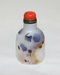 Chinese shadow agate snuff bottle, late 18th/early 19th century, carved in low relief with butterflies and prunus branches, carved footrim, coral stopper