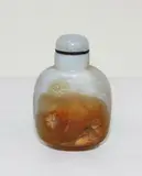 Chinese agate snuff bottle, late 18th/early 19th century, carved with young man in a mountainous landscape with a single flower, carved footrim