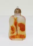 Chinese agate flat snuff bottle, probably early 20th century, carved in relief with a leaping fish with a lotus leaf and bud
