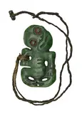 Mike Higgs, A good pounamu Hei Tiki, Kawakawa variety. Modelled with titled head and one three fingered hand place to the abdomen the other to the thigh.
