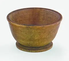 A Chinese turned rhinocerous cup, 19th century, the slightly rounded sides issuing from a shallow circular solid base to a flat everted rim, two carved parallel lines just below the rim