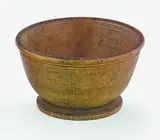 A Chinese turned rhinocerous cup, 19th century, the slightly rounded sides issuing from a shallow circular solid base to a flat everted rim, two carved parallel lines just below the rim