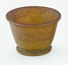 A Chinese turned rhinocerous cup, 19th century, the slightly flaring sides issuing from a shallow circular solid base to a flat everted rim, two carved parallel lines just below the rim