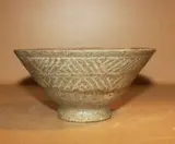 A Korean grey celadon bowl, Koryo Dynasty (12th-14th Century), with slip decoration of bands with geometric design, together with four Korean small celadon dishes