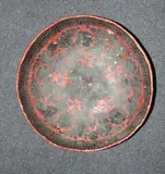 probably 19th Century by A South-East Asian red and lacquer bowl, decorated with a stylized flower and fruit pattern, offered Feb 2012