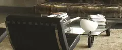 Industrial designer, glass coffee table, on wheels in center of installation shot