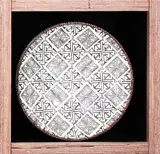 Steven Scholefield, White surfaced high fired earthenware dish impressed with a pattern of Theo Schoon's stamps., Impressed pottery mark, artists cipher and dated 2003.