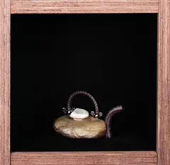 Porcelain teapot by Peter Lange, Modeled as a rock with a stone lid and rebar spout and handle, sold Oct 2007