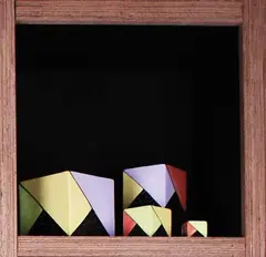 Jean van der Putten, Set of four graduated cubes painted with geometric panels, Largest 125mm2, smallest 35mm2