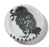 Pablo Picasso, Oiseau au ver (Bird with Worm) (A.R. 172), 1952, White earthenware round ashtray painted in black with partial brushed glaze; ceramic, Madoura edition