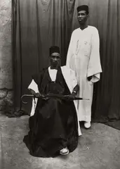 Homme Assis Avec Parapluie, Homme Debout En Blanc by Seydou Keïta, 1952-1955, Gelatin silver print, printed 1996, sold Apr 2026