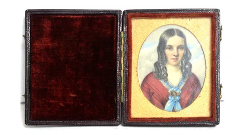 Portrait of a young lady in a crimson dress by 19th Century British School, tempera on ivory, sold Feb 2024
