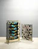 Arman, Formula One, 2005, sliced Renault F1 toy racecars embedded in polyester resin