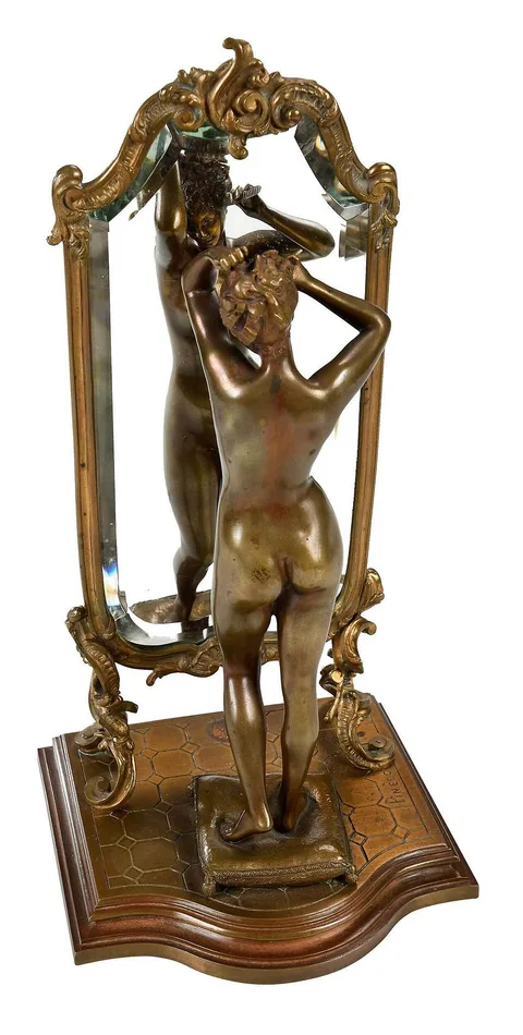 Woman Combing Hair in Front of a Mirror by Émile Pinedo, patinated bronze, sold Jul 2022