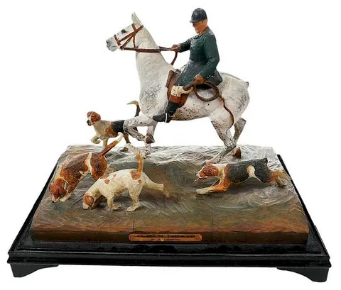 Untitled by R.H. Buxton, carved and painted scene of a hunter on horseback with hunting dogs, sold Dec 2019