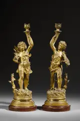 Da un modello di. Coppia di candelabri in bronzo dorato in forma di amorini alati reggifiaccola (allegorie di Autunno e Primavera) by Ernest Rancoulet, sculpture, sold Feb 2023