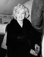 Marilyn Monroe with bandaged thumb and flower by Kashio Aoki, 1954, Black and white photograph, sold May 2007