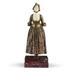 Georges Van der Straeten, YOUNG WOMAN IN A FLORAL SKIRT, patinated bronze and carved ivory, the figure modelled leaning forward with her hands clasped behind her back