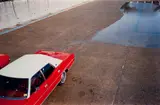 Untitled (red car) by William Eggleston, circa 1970-1974, Dye transfer print, printed 2012, sold Mar 2025