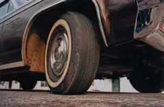 Untitled (tire reflection) by William Eggleston, circa 1970-1974, Dye transfer print, printed 2012, sold Mar 2025