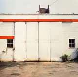 Untitled (white wall, red trim) by William Eggleston, circa 1971, Dye transfer print, printed 1999, sold Mar 2025