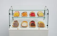 Claes Oldenburg, 24 Open-Faced Sandwiches, 1964, burlap soaked in plaster, tempera, porcelain plates, glass and metal case