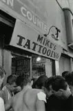 Bruce Davidson, Outside Mike’s Tattoo Shop in Coney Island, N.Y., from Brooklyn Gang, 1959, Gelatin silver print, printed later