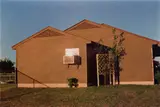 Untitled, Memphis, TN (brown house in sunshine) by William Eggleston, circa 1971-1974, Dye transfer print, printed 2004 from Dust Bells Volume II, sold Apr 2024