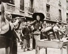 Elise Daniels with Street Performers, Suit by Balenciaga, Le Marais, Paris, August by Richard Avedon, 1948, Gelatin silver print from Avedon/Paris , printed 1978, sold Oct 2024