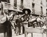 Richard Avedon, Elise Daniels with Street Performers, Suit by Balenciaga, Le Marais, Paris, August