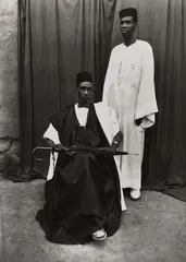 Homme Assis Avec Parapluie, Homme Debout En Blanc by Seydou Keïta, 1952-1955, Gelatin silver print, printed 1996, offered Oct 2024