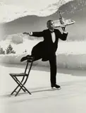 Alfred Eisenstaedt, Rene Breguet serves cocktails at the Grand Hotel ice rink, St. Moritz